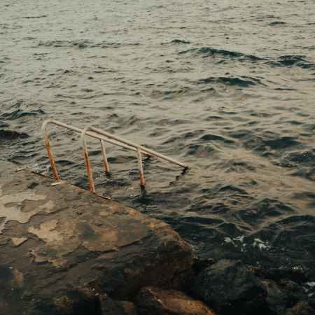 stairs railing disappearing into sea
